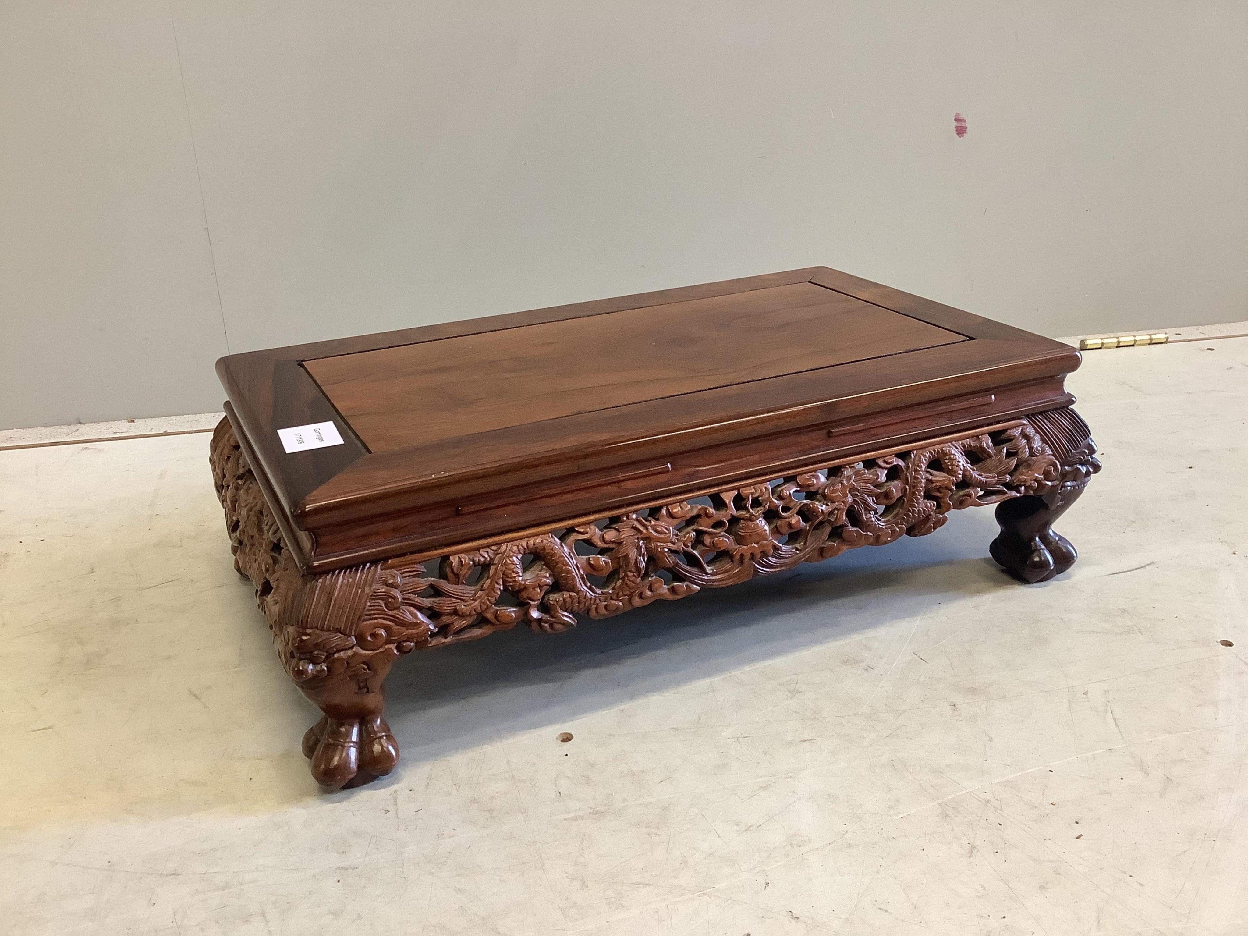 A Chinese rectangular rosewood stand or low table, width 56cm, depth 33cm, height 18cm. Condition - good